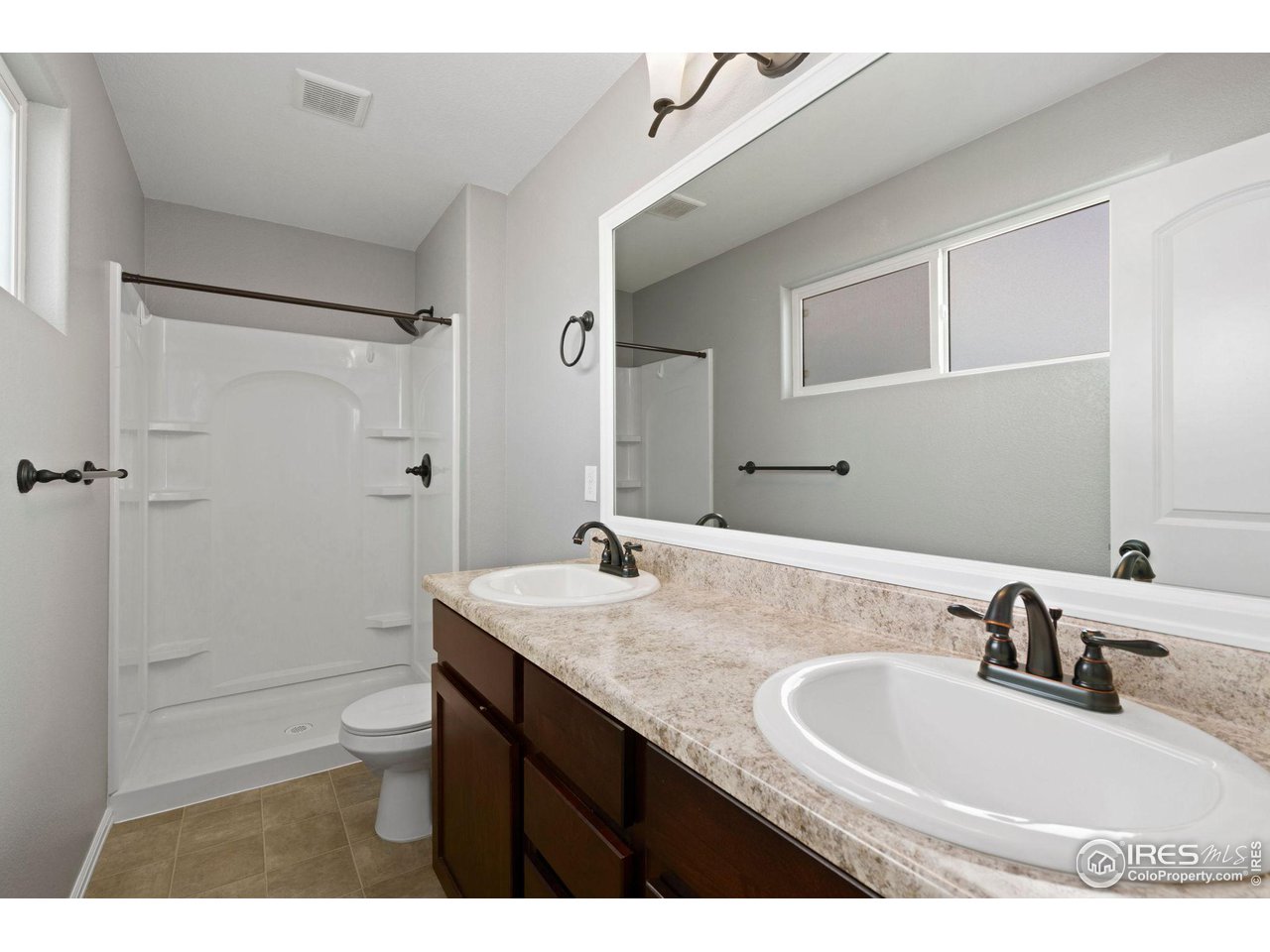 856 Sunlight Peak Drive Severance, CO 80550 - Photo 22 of 40 a bathroom with a sink and mirror with toilet
