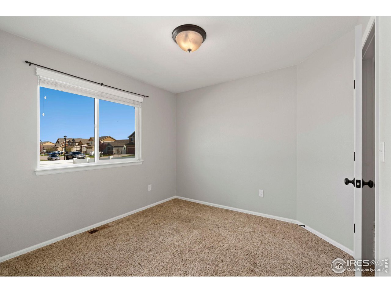 856 Sunlight Peak Drive Severance, CO 80550 - Photo 26 of 40 a view of an empty room with a window