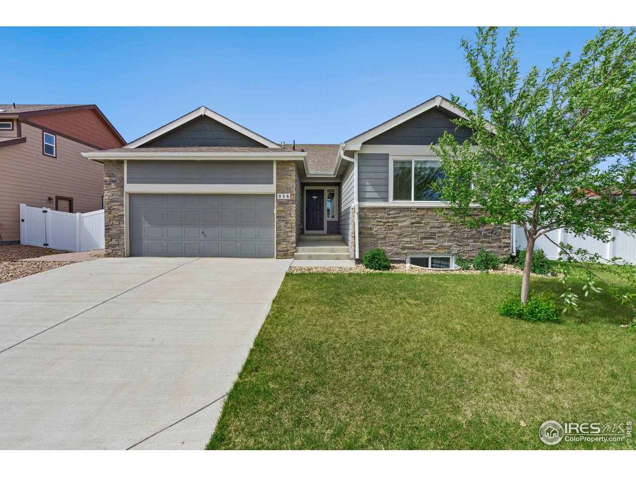 856 Sunlight Peak Drive Severance, CO 80550 - Photo 3 of 40 a front view of a house with a yard and garage
