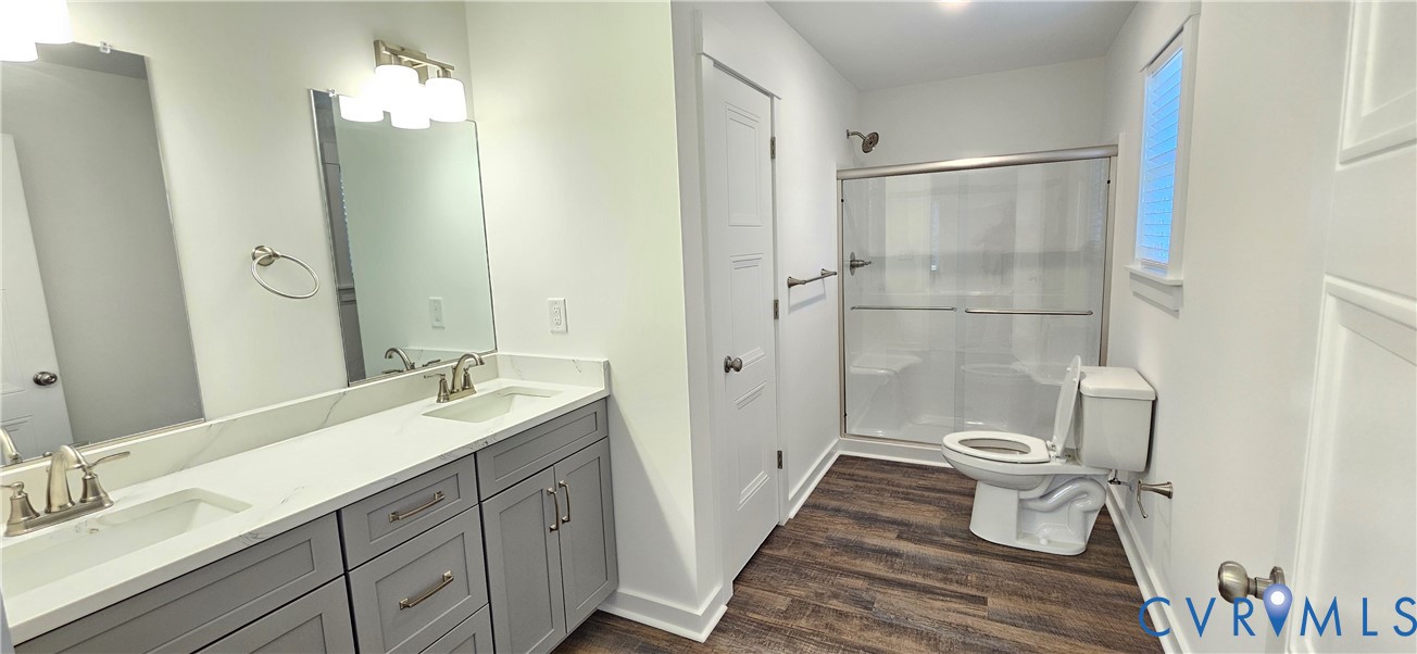 1929 Howerton Road Dunnsville, VA 22454 - Photo 12 of 16 a bathroom with a double vanity sink toilet and shower