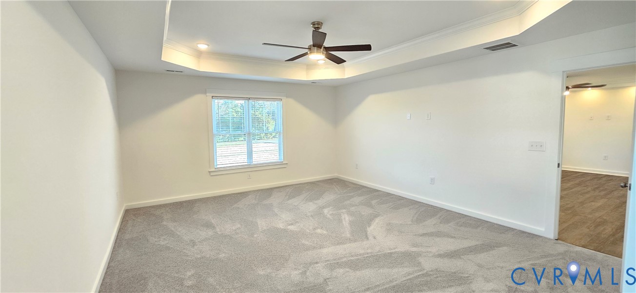 1929 Howerton Road Dunnsville, VA 22454 - Photo 12 of 17 an empty room with windows and ceiling fan