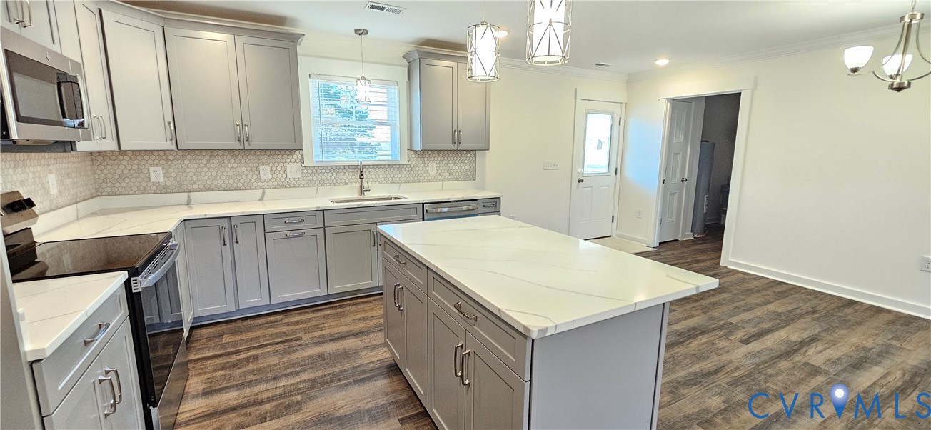 1929 Howerton Road Dunnsville, VA 22454 - Photo 4 of 16 a kitchen with a sink stove and refrigerator