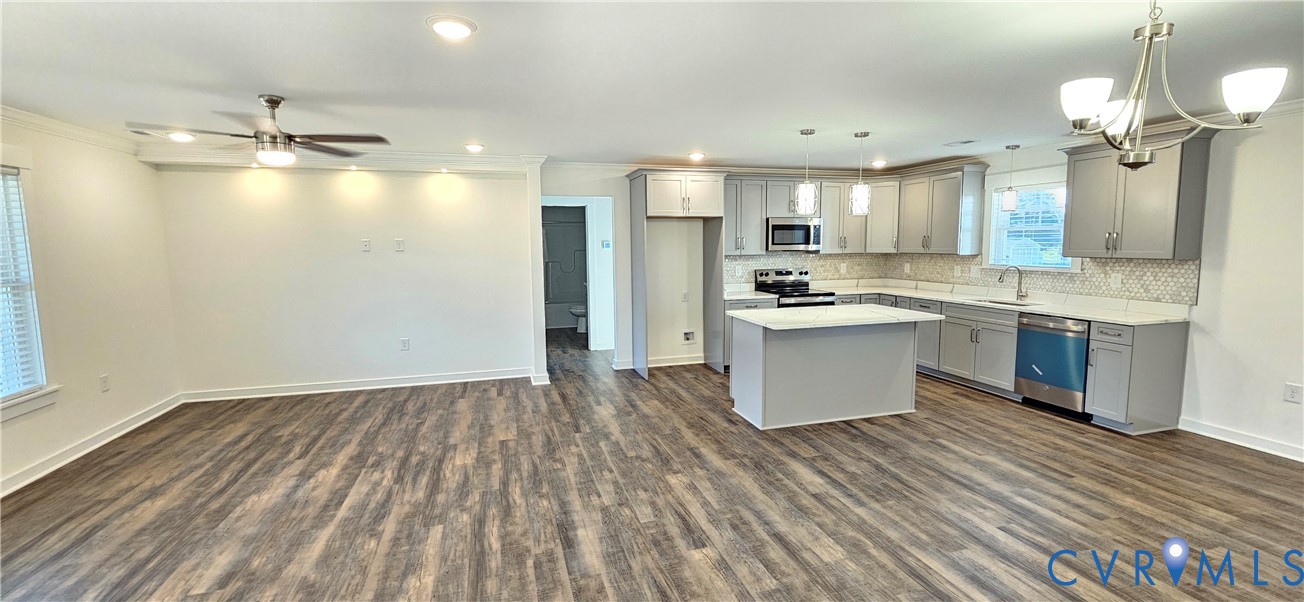 1929 Howerton Road Dunnsville, VA 22454 - Photo 6 of 17 a kitchen with kitchen island a sink and wooden floor