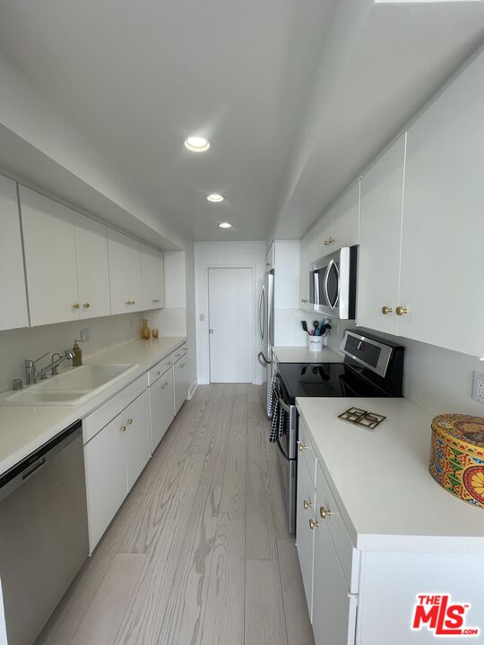 2222 Avenue Of The Stars, Unit 705 Los Angeles, CA 90067 - Photo 11 of 36 a kitchen that has a sink and a stove in it
