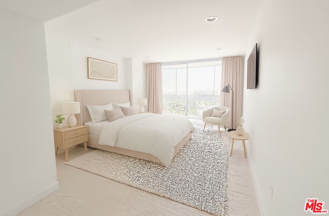 2222 Avenue Of The Stars, Unit 705 Los Angeles, CA 90067 - Photo 17 of 36 a bedroom with a large bed and a night stand