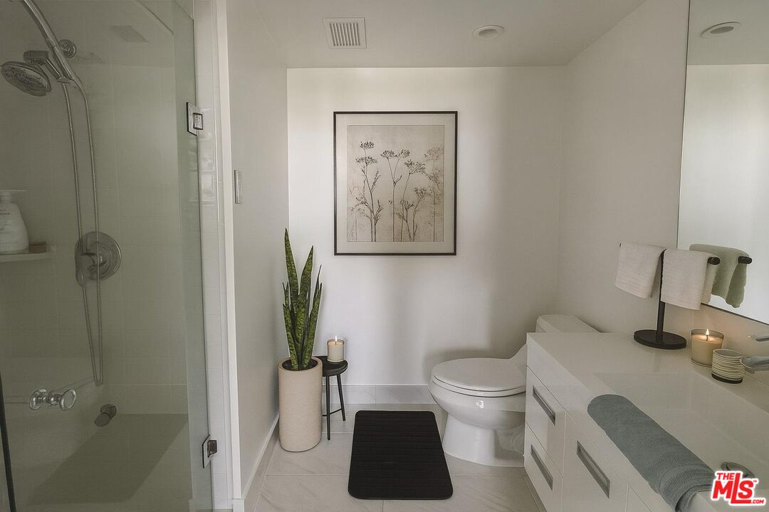 2222 Avenue Of The Stars, Unit 705 Los Angeles, CA 90067 - Photo 20 of 36 a bathroom with a toilet a sink and shower
