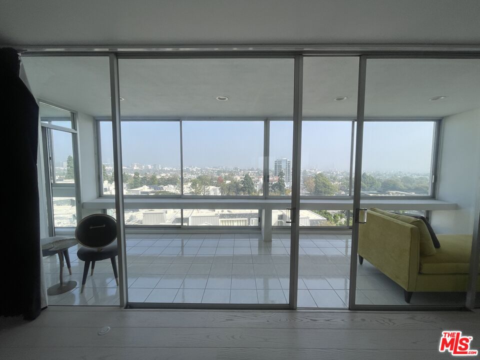 2222 Avenue Of The Stars, Unit 705 Los Angeles, CA 90067 - Photo 32 of 36 a living room with furniture and a floor to ceiling window