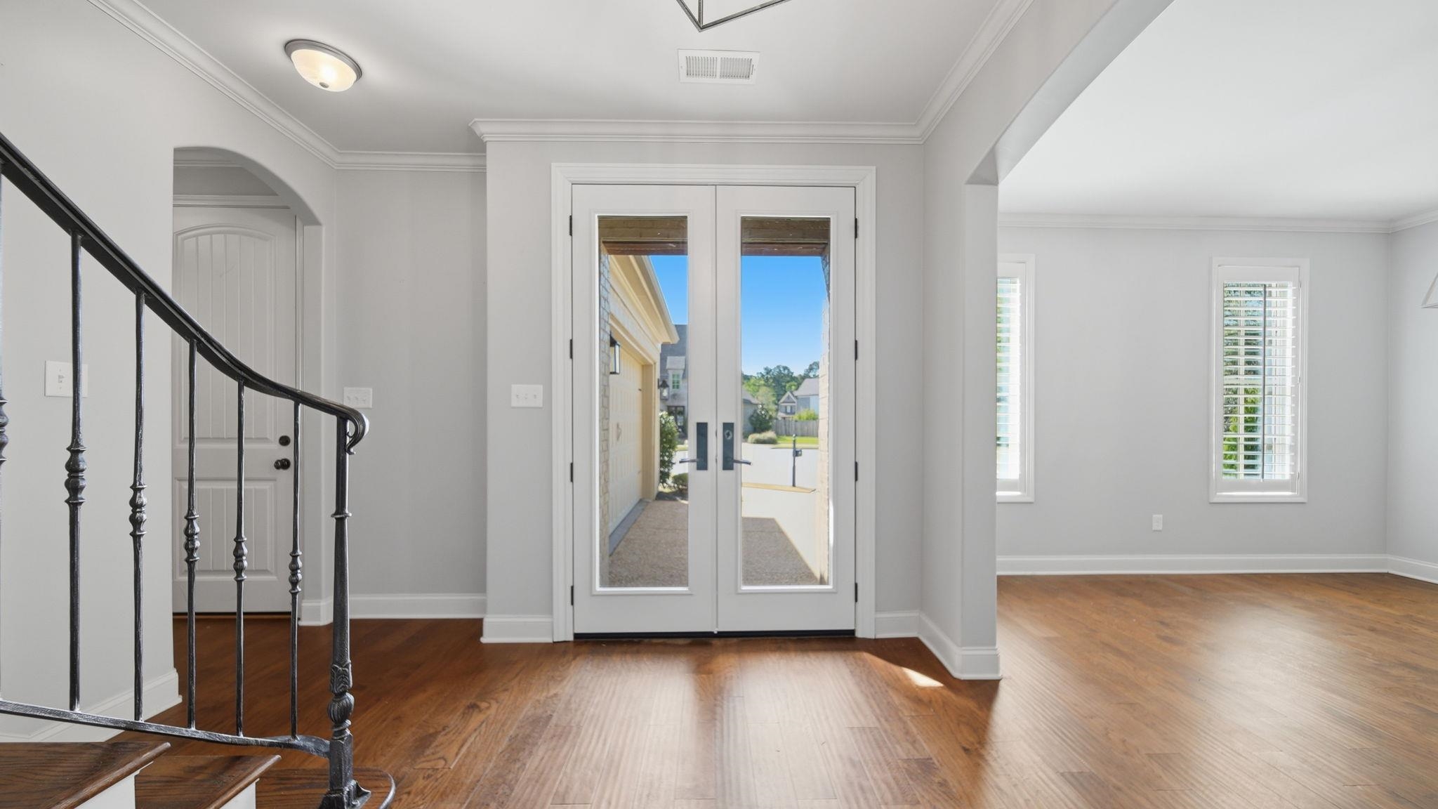 1058 Shanborne Cove Collierville, TN 38017 - Photo 11 of 39 Foyer entrance featuring french doors, dark wood finished floors, arched walkways, and ornamental molding