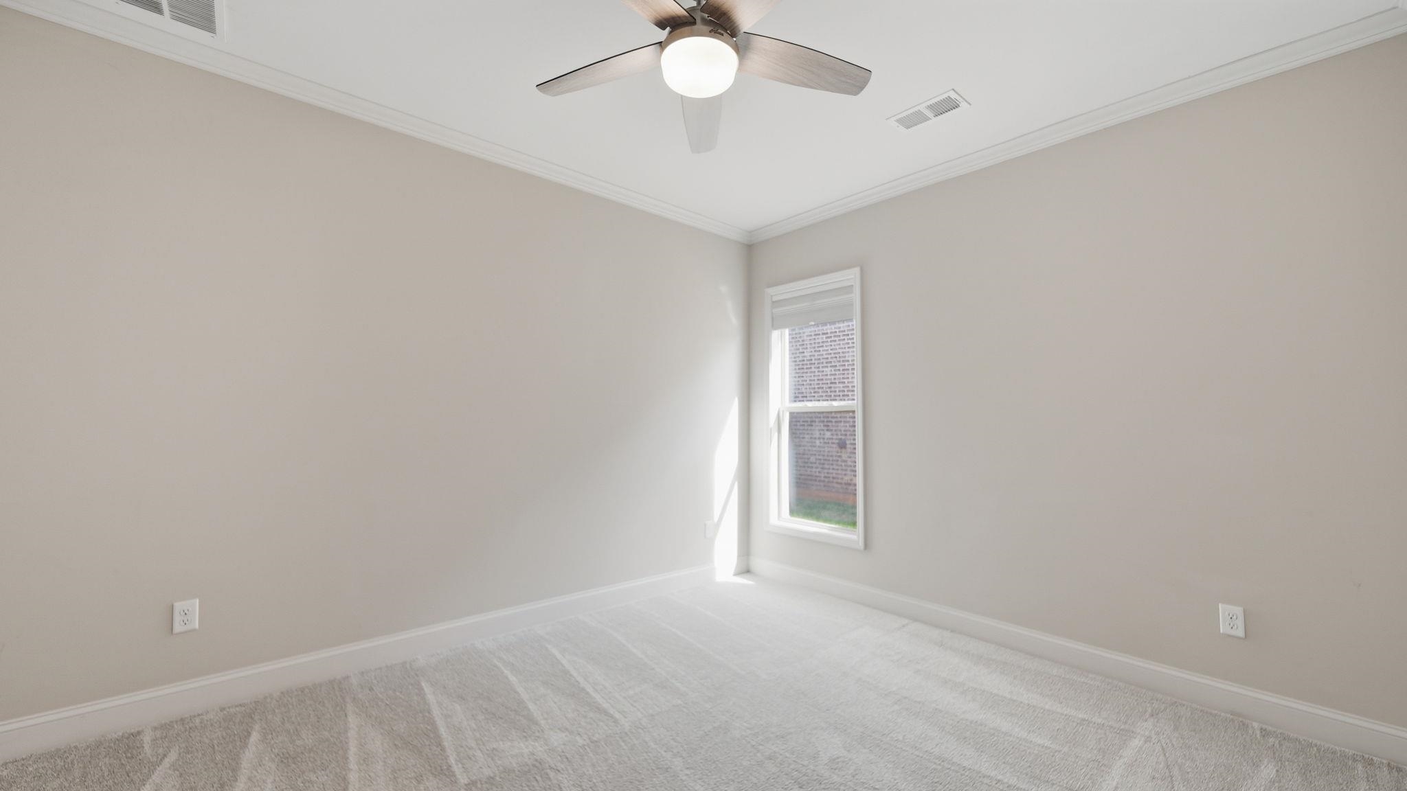 1058 Shanborne Cove Collierville, TN 38017 - Photo 16 of 39 Empty room with crown molding, light colored carpet, and ceiling fan