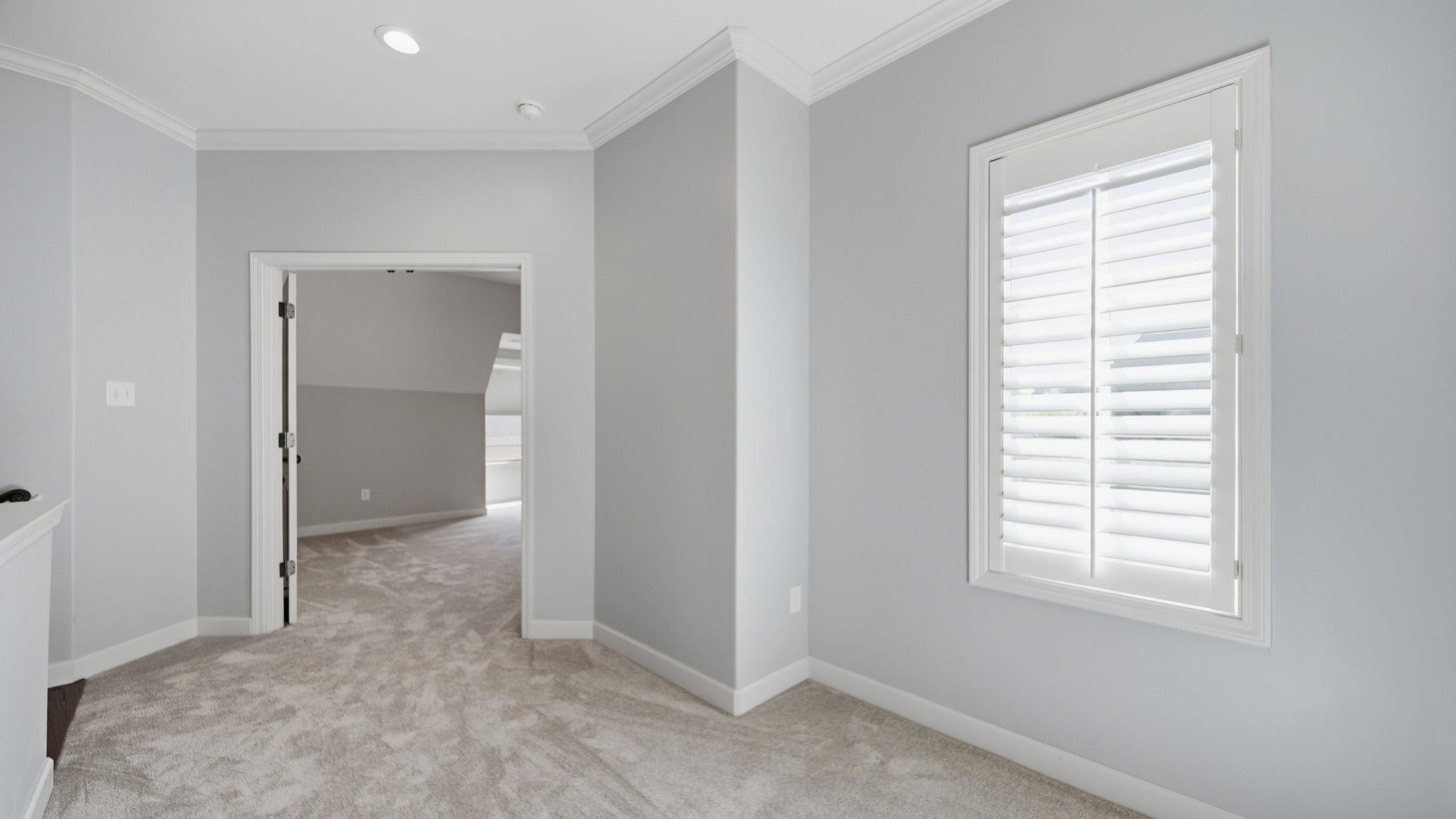 1058 Shanborne Cove Collierville, TN 38017 - Photo 32 of 39 Unfurnished room with light colored carpet and crown molding