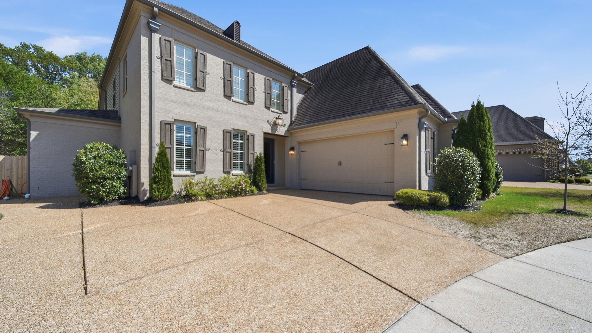 1058 Shanborne Cove Collierville, TN 38017 - Photo 38 of 39 View of front of property with concrete driveway, a garage, and brick siding