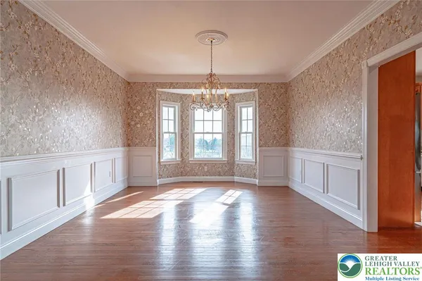 a large kitchen with stainless steel appliances granite countertop a large stove a sink dishwasher and a refrigerator with wooden cabinets