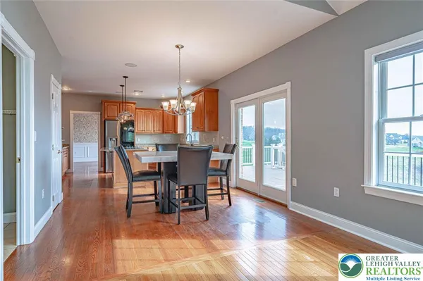 an empty room with wooden floor a fireplace and a window