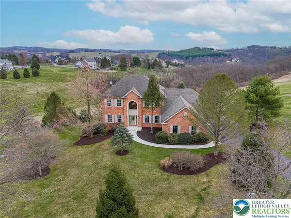 an aerial view of residential houses with outdoor space and a lake view