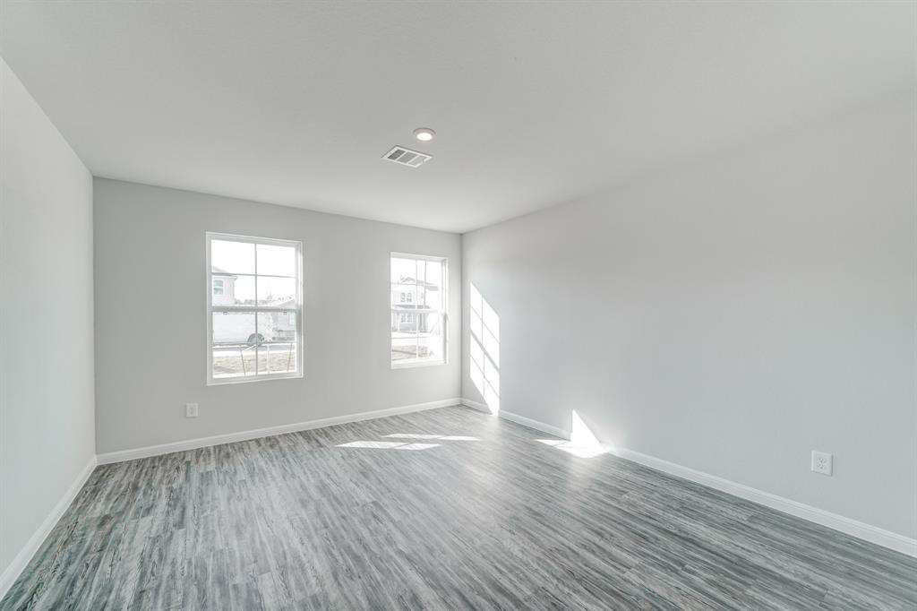 3542 Silver Springs Abilene, TX 79602 - Photo 8 of 16 an empty room with wooden floor and windows