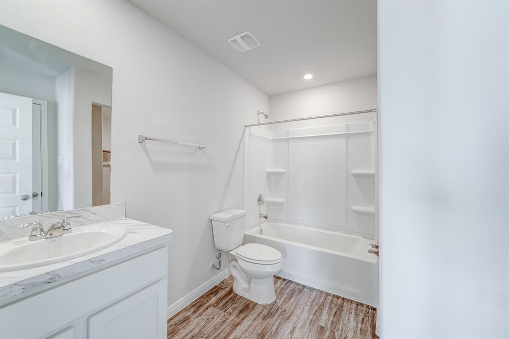 3542 Silver Springs Abilene, TX 79602 - Photo 10 of 16 a bathroom with a granite countertop sink toilet a mirror and shower