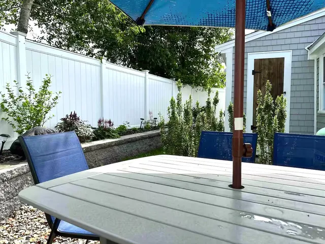 a wooden bench sitting in front of a building