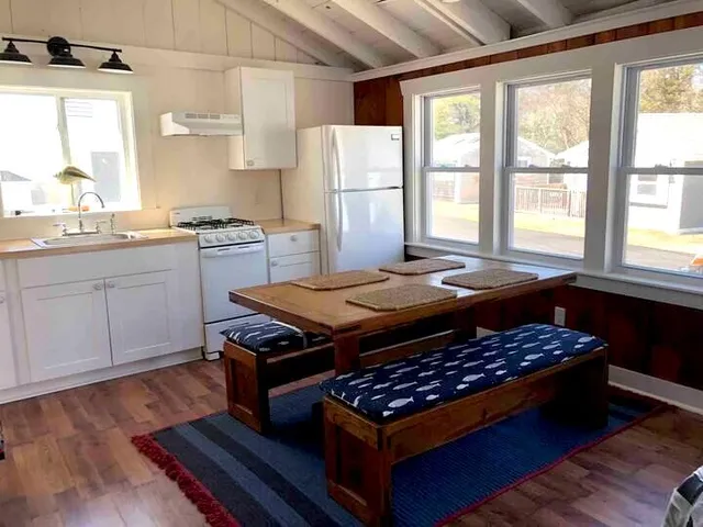 a bed sitting in a kitchen next to a window