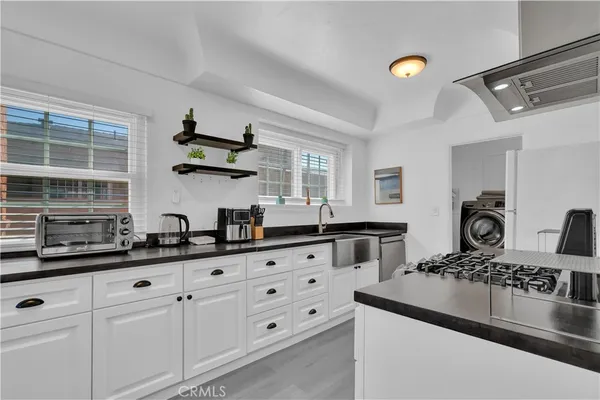 a kitchen with cabinets and window