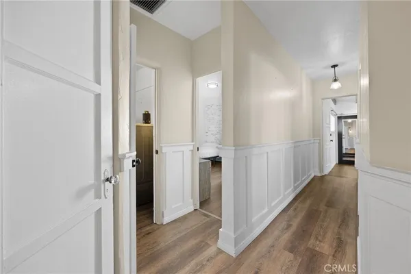 a view of a hallway with wooden floor