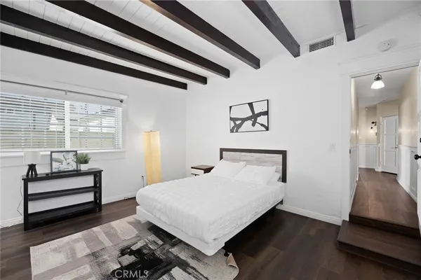a bedroom with a bed and a large window