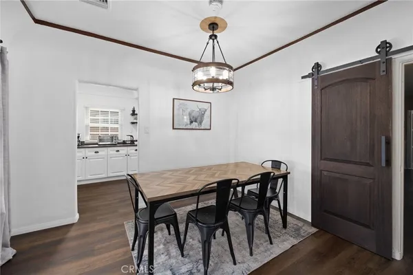 a view of a dining room with furniture wooden floor and a chandelier
