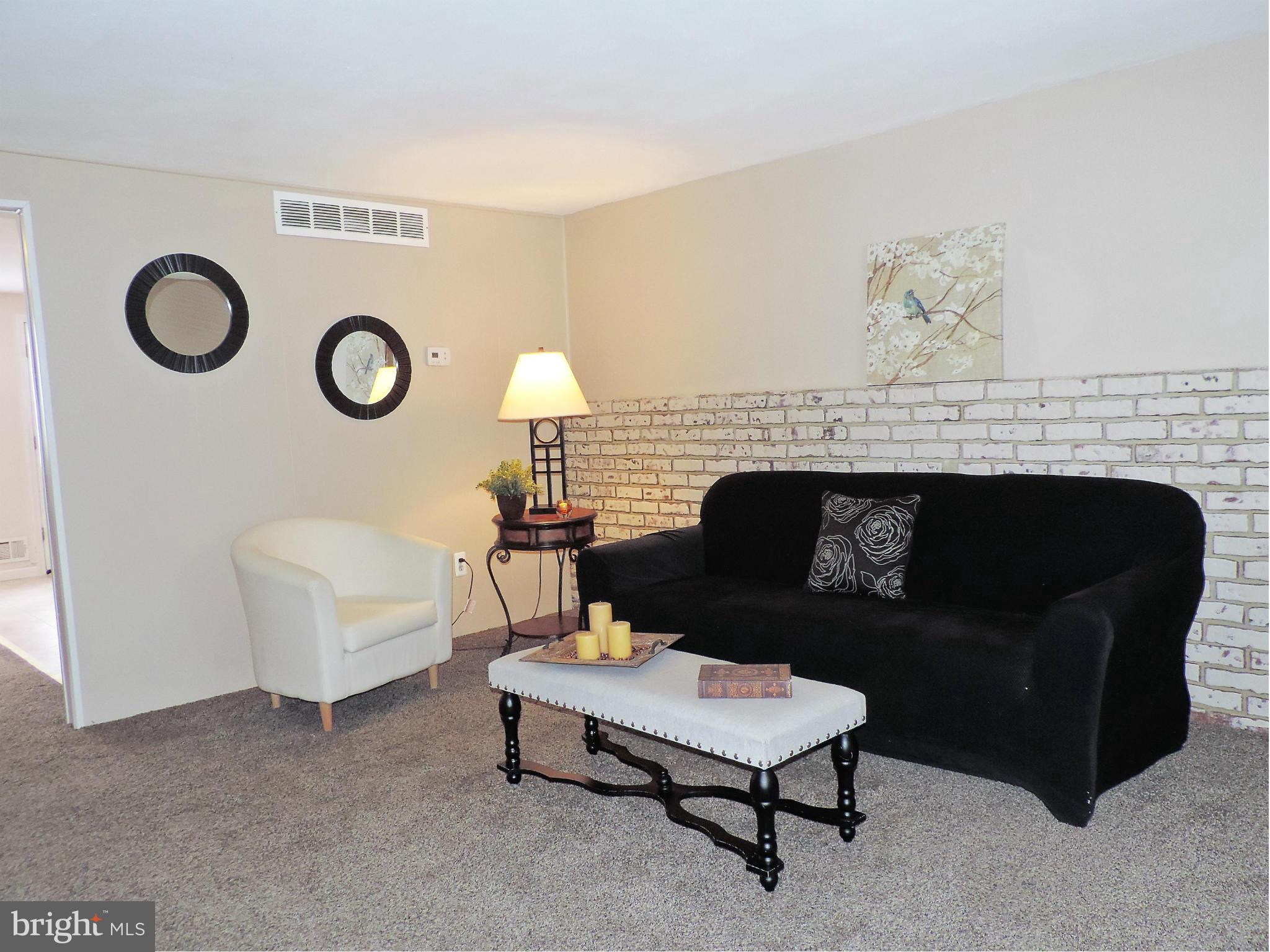 952 Bayner Road Essex, MD 21221 - Photo 3 of 17 a living room with furniture and a fireplace