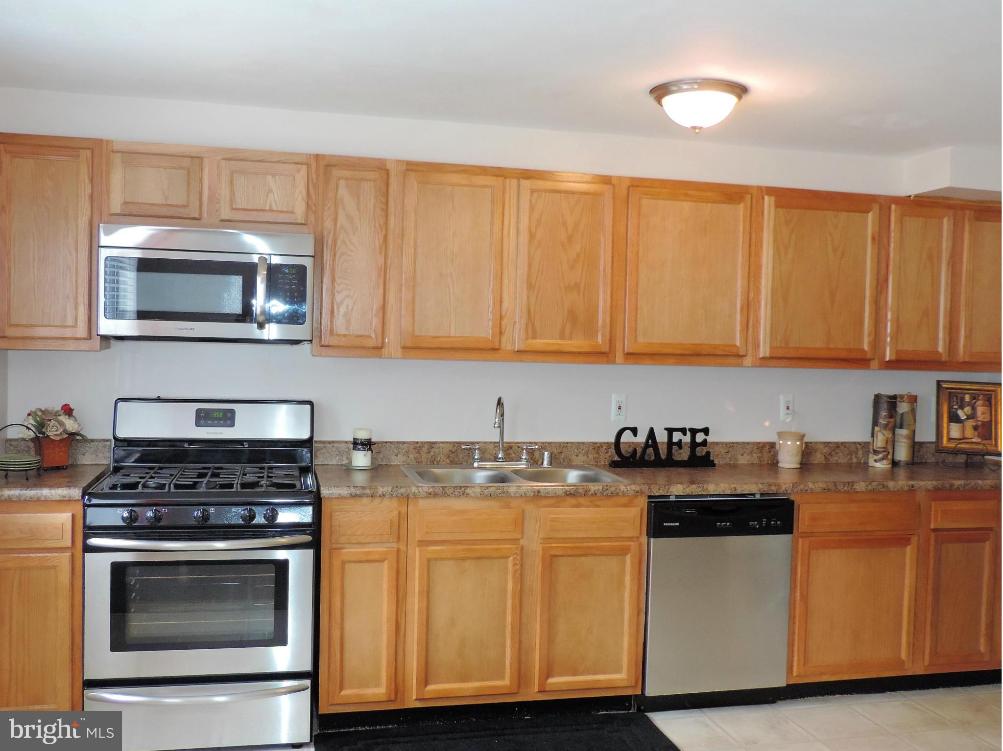952 Bayner Road Essex, MD 21221 - Photo 7 of 17 a kitchen with granite countertop cabinets stainless steel appliances and a sink