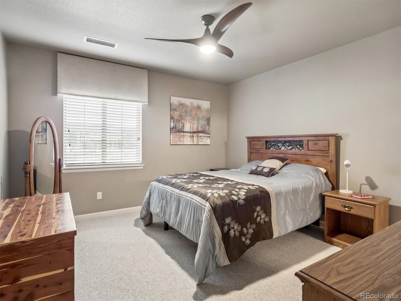 1144 Rockhurst Drive, Unit 107 Highlands Ranch, CO 80129 - Photo 11 of 29 a bedroom with a bed and window