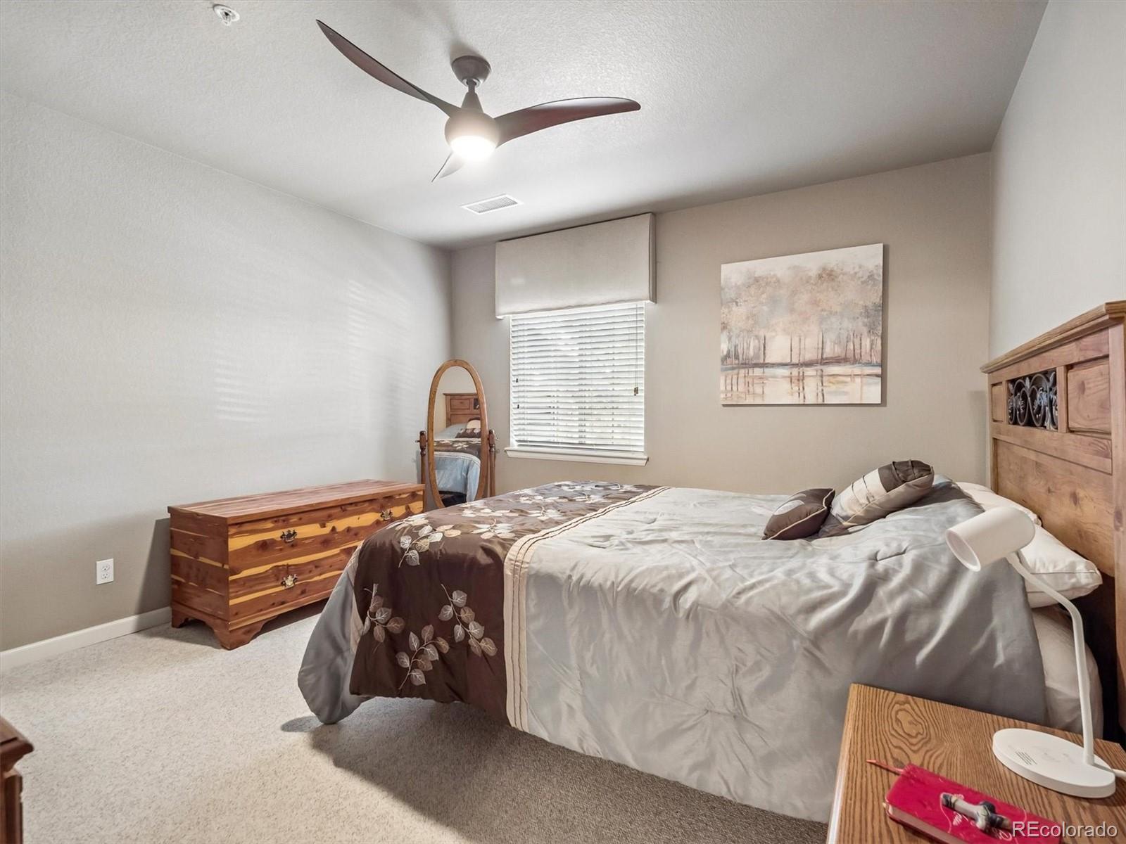 1144 Rockhurst Drive, Unit 107 Highlands Ranch, CO 80129 - Photo 13 of 29 a bedroom with bed and window