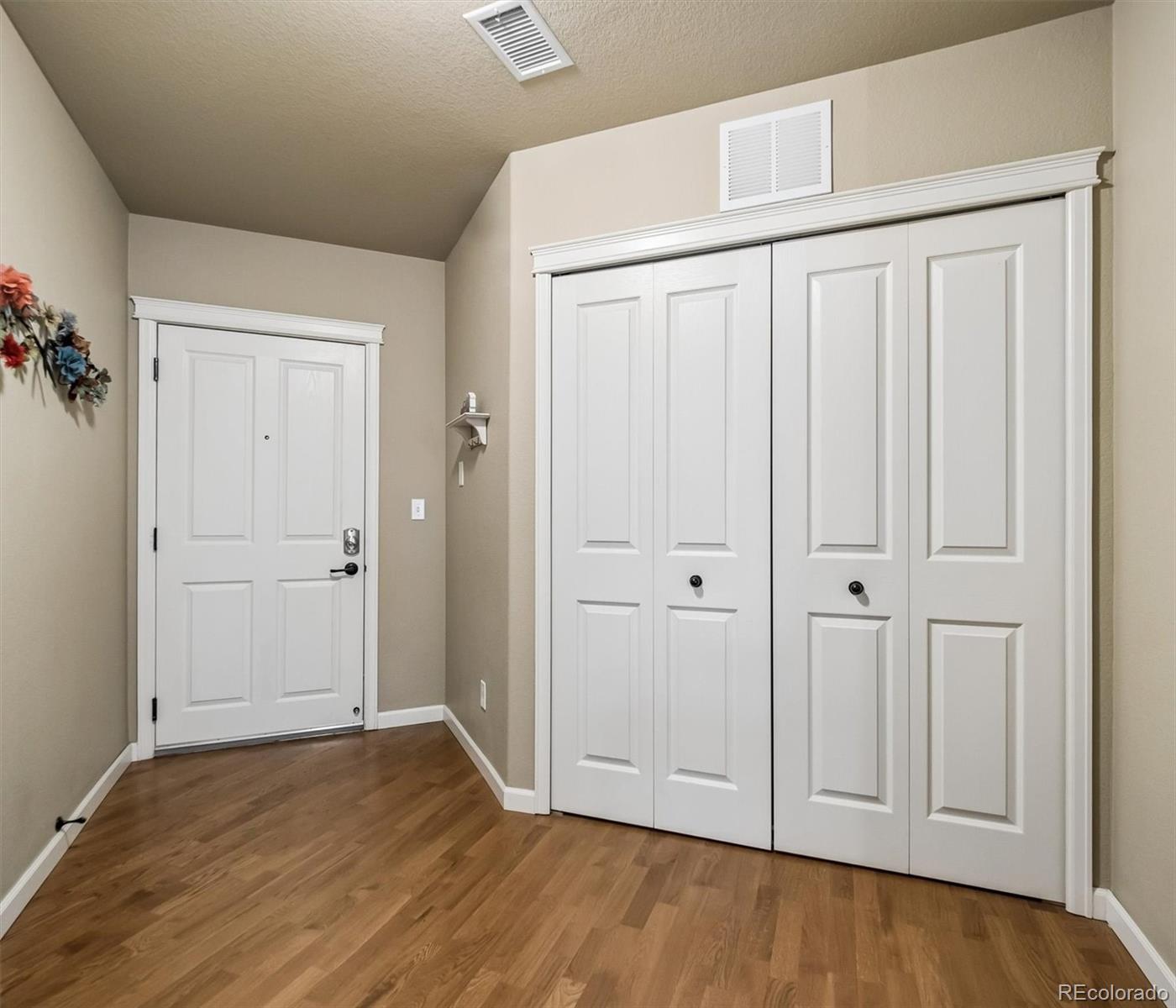 1144 Rockhurst Drive, Unit 107 Highlands Ranch, CO 80129 - Photo 17 of 29 a view of empty room with wooden floor