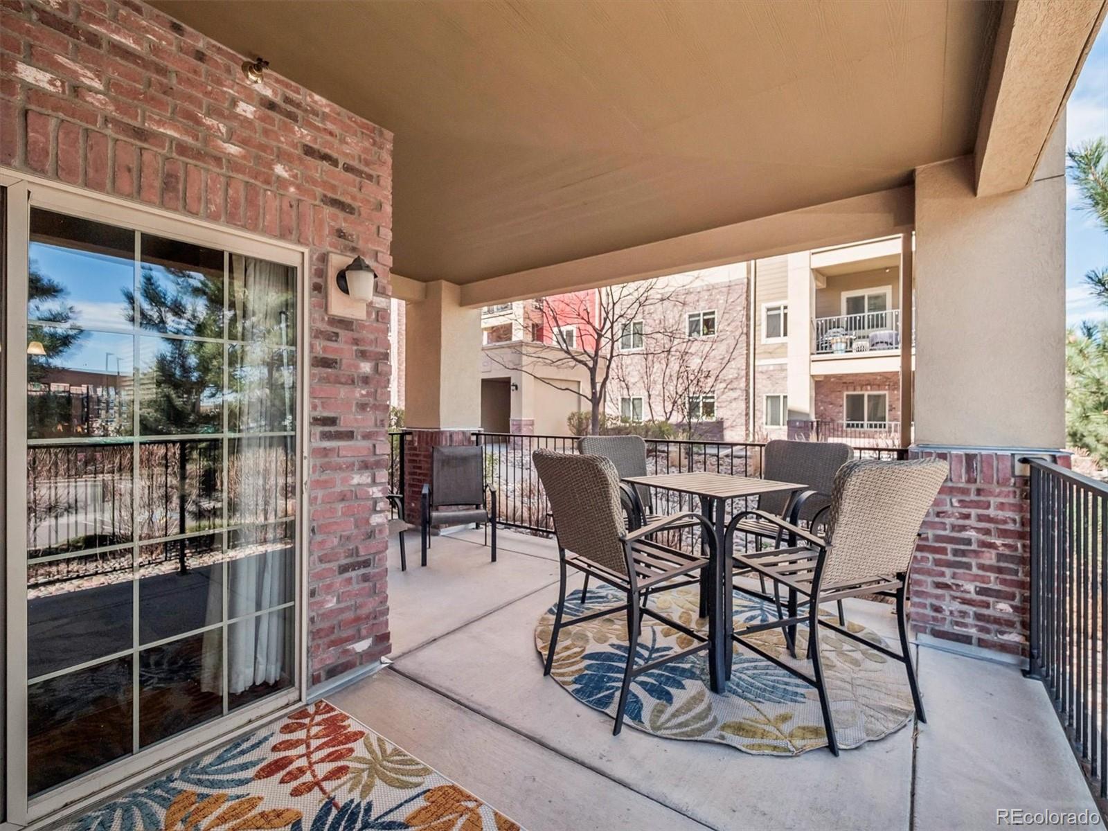 1144 Rockhurst Drive, Unit 107 Highlands Ranch, CO 80129 - Photo 19 of 29 a dining room with furniture and a floor to ceiling window
