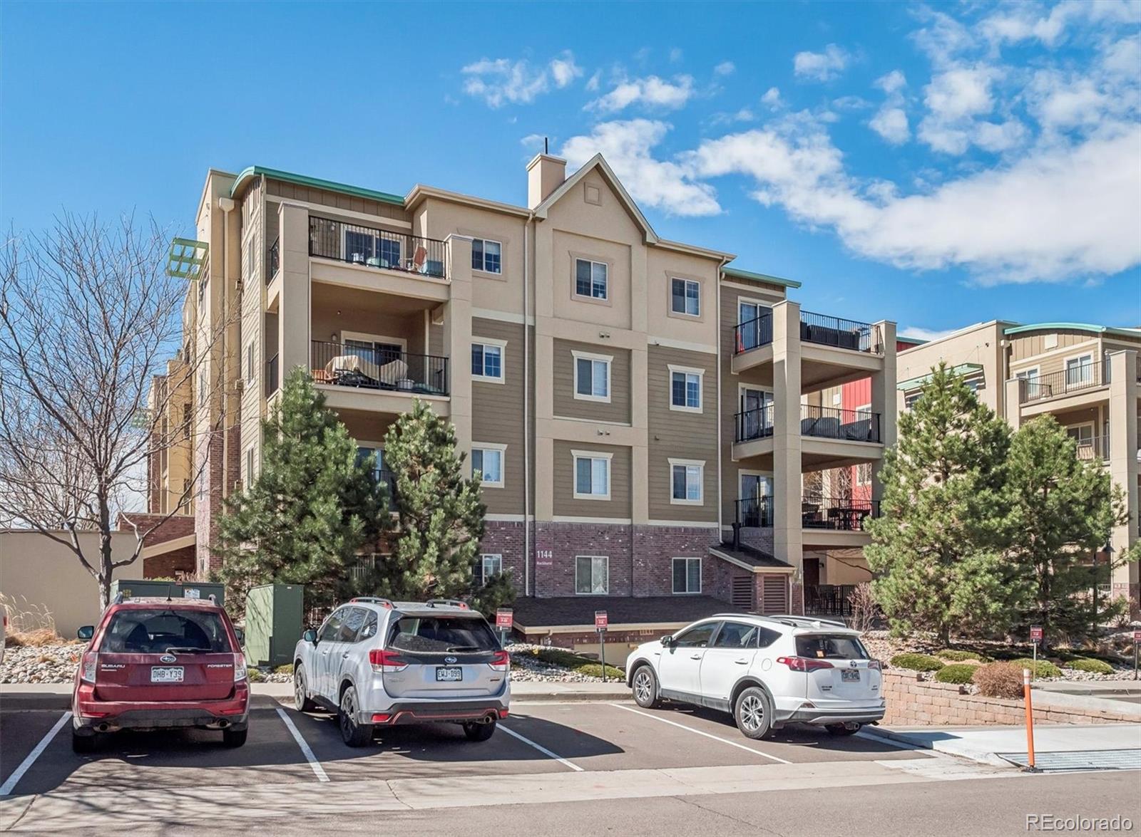 1144 Rockhurst Drive, Unit 107 Highlands Ranch, CO 80129 - Photo 23 of 29 a car parked in front of a building