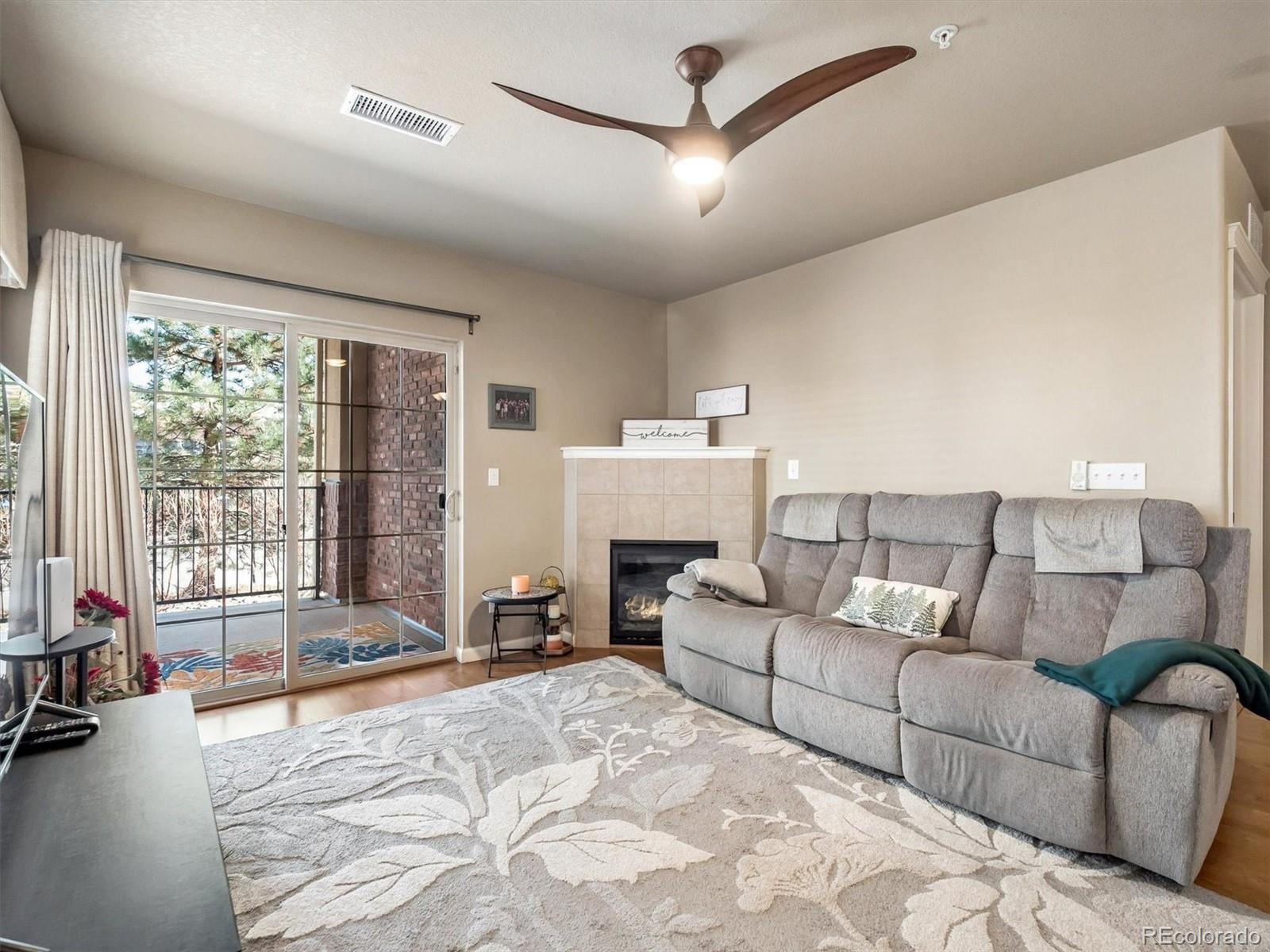 1144 Rockhurst Drive, Unit 107 Highlands Ranch, CO 80129 - Photo 5 of 29 a living room with furniture and a large window
