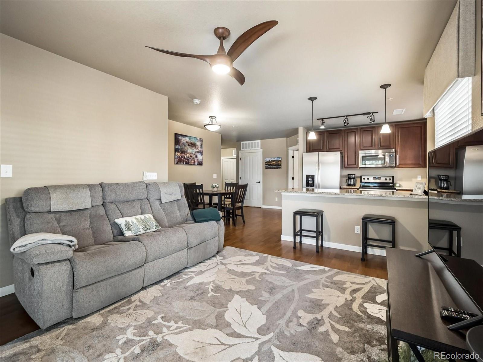 1144 Rockhurst Drive, Unit 107 Highlands Ranch, CO 80129 - Photo 6 of 29 a living room with furniture and kitchen view