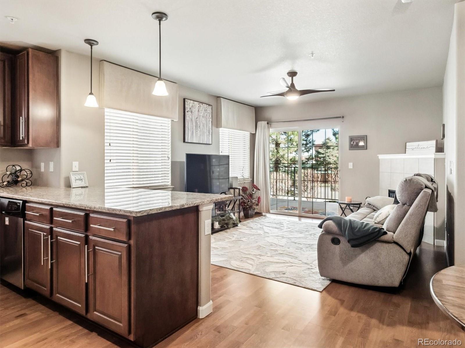 1144 Rockhurst Drive, Unit 107 Highlands Ranch, CO 80129 - Photo 7 of 29 a kitchen with stainless steel appliances granite countertop a stove and a large window