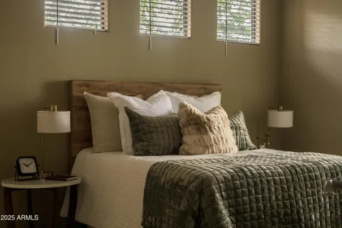 a bedroom with a bed and a window