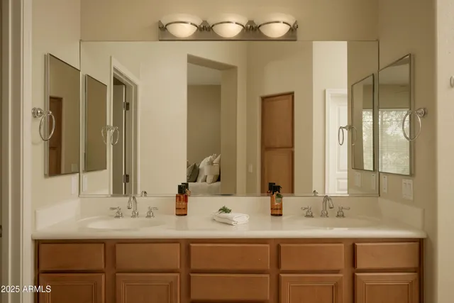 a bathroom with a double vanity sink and a mirror