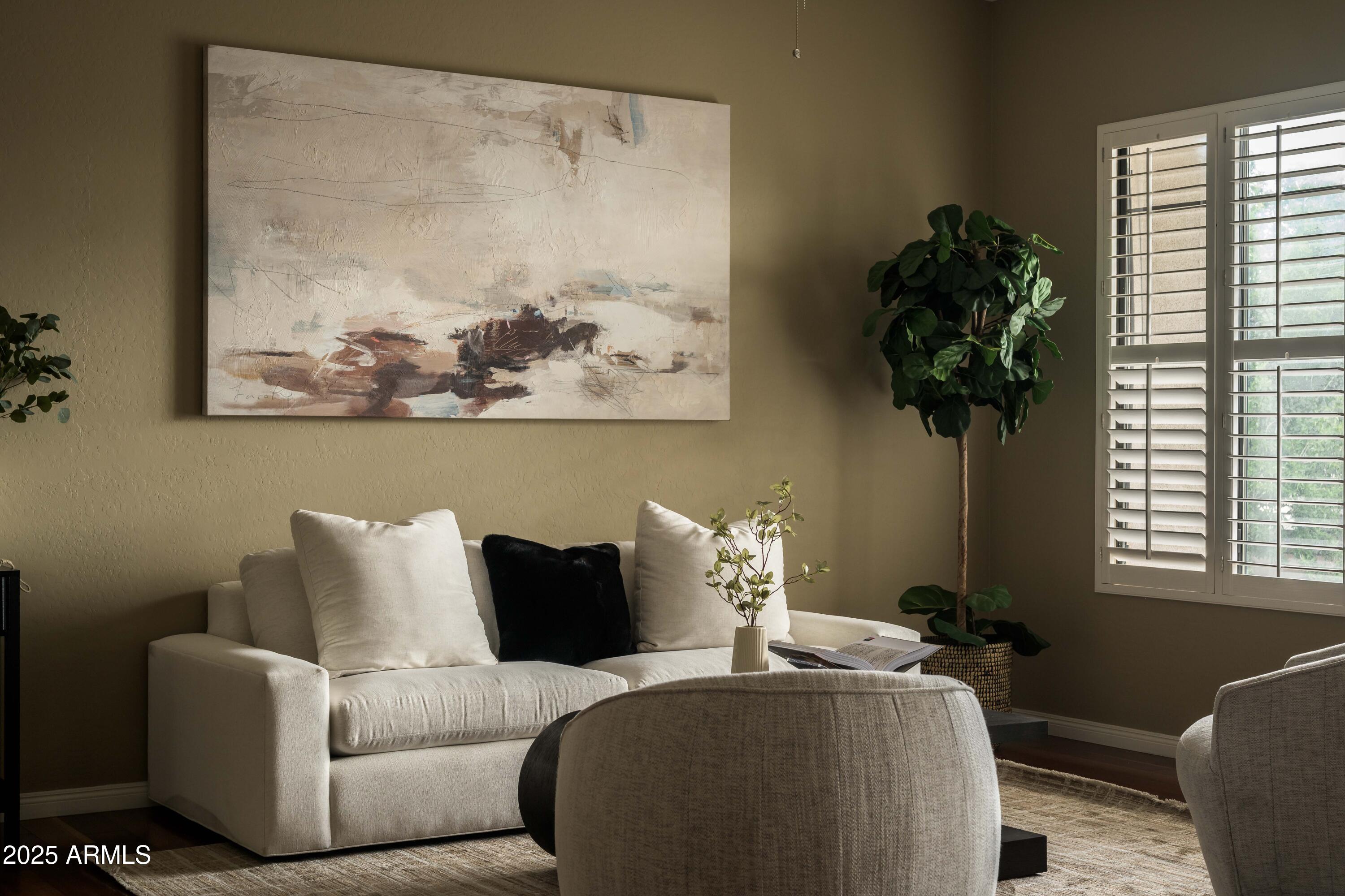 2989 North 44th Street, Unit 2007 Phoenix, AZ 85018 - Photo 2 of 29 a living room with furniture plant and a window