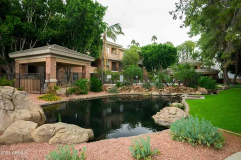 a view of a swimming pool with a patio and a garden