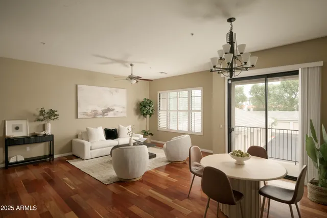 a living room with furniture and a chandelier