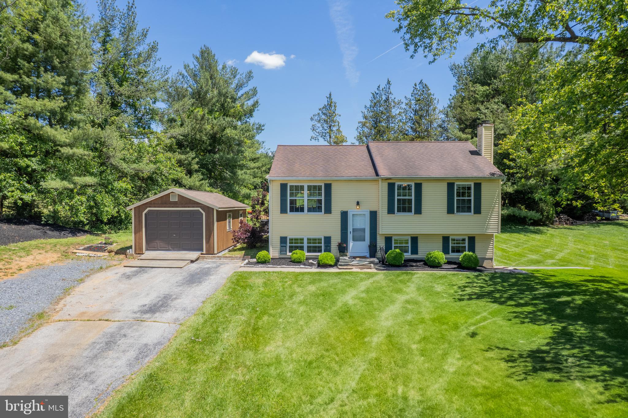 a view of a house with a yard and sitting area