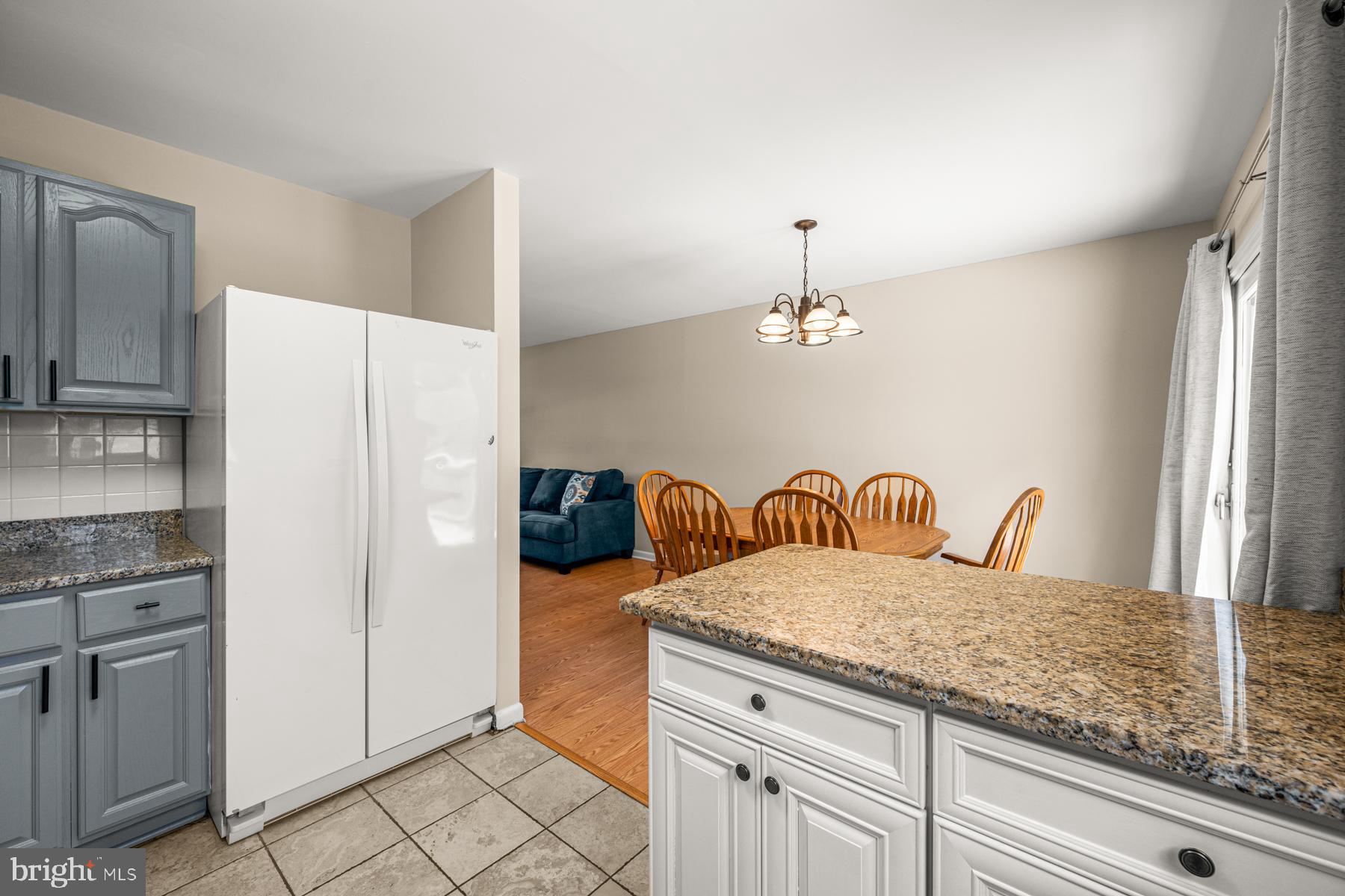 4285 Wolf Hill Drive Hampstead, MD 21074 - Photo 11 of 49 a kitchen with granite countertop a refrigerator and a stove top oven