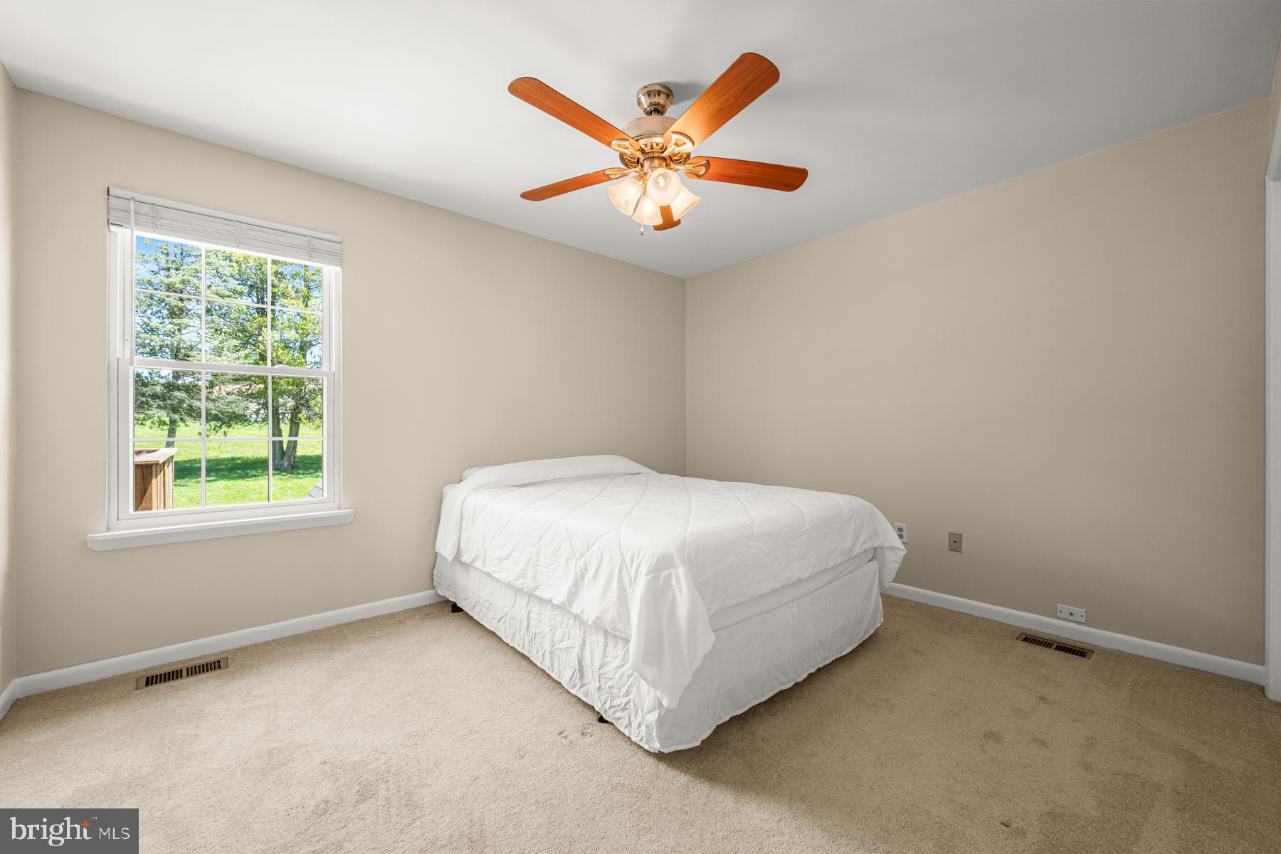 4285 Wolf Hill Drive Hampstead, MD 21074 - Photo 13 of 49 a bed sitting in a bedroom next to a window