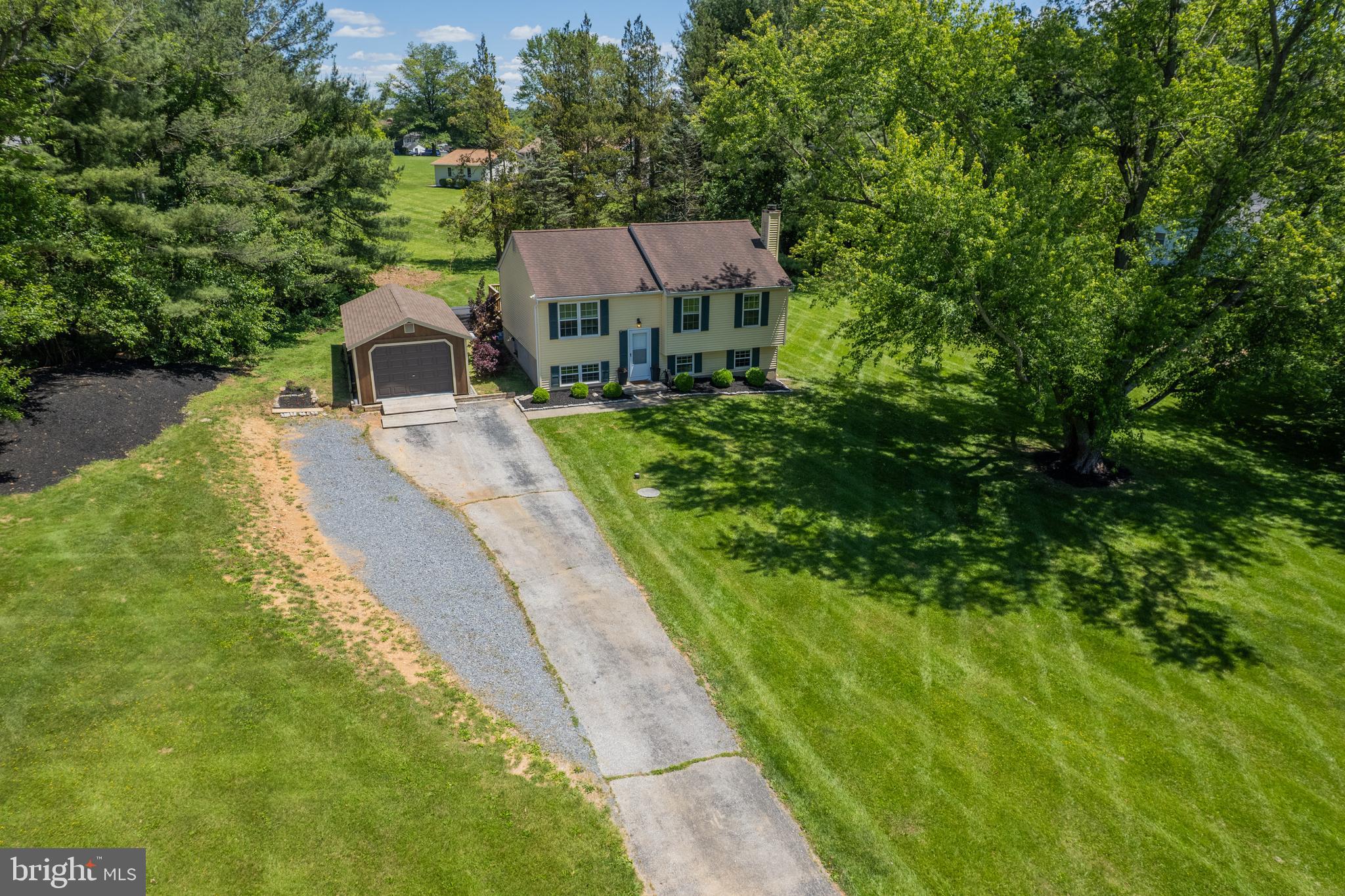 4285 Wolf Hill Drive Hampstead, MD 21074 - Photo 46 of 49 a front view of a house with a yard and trees