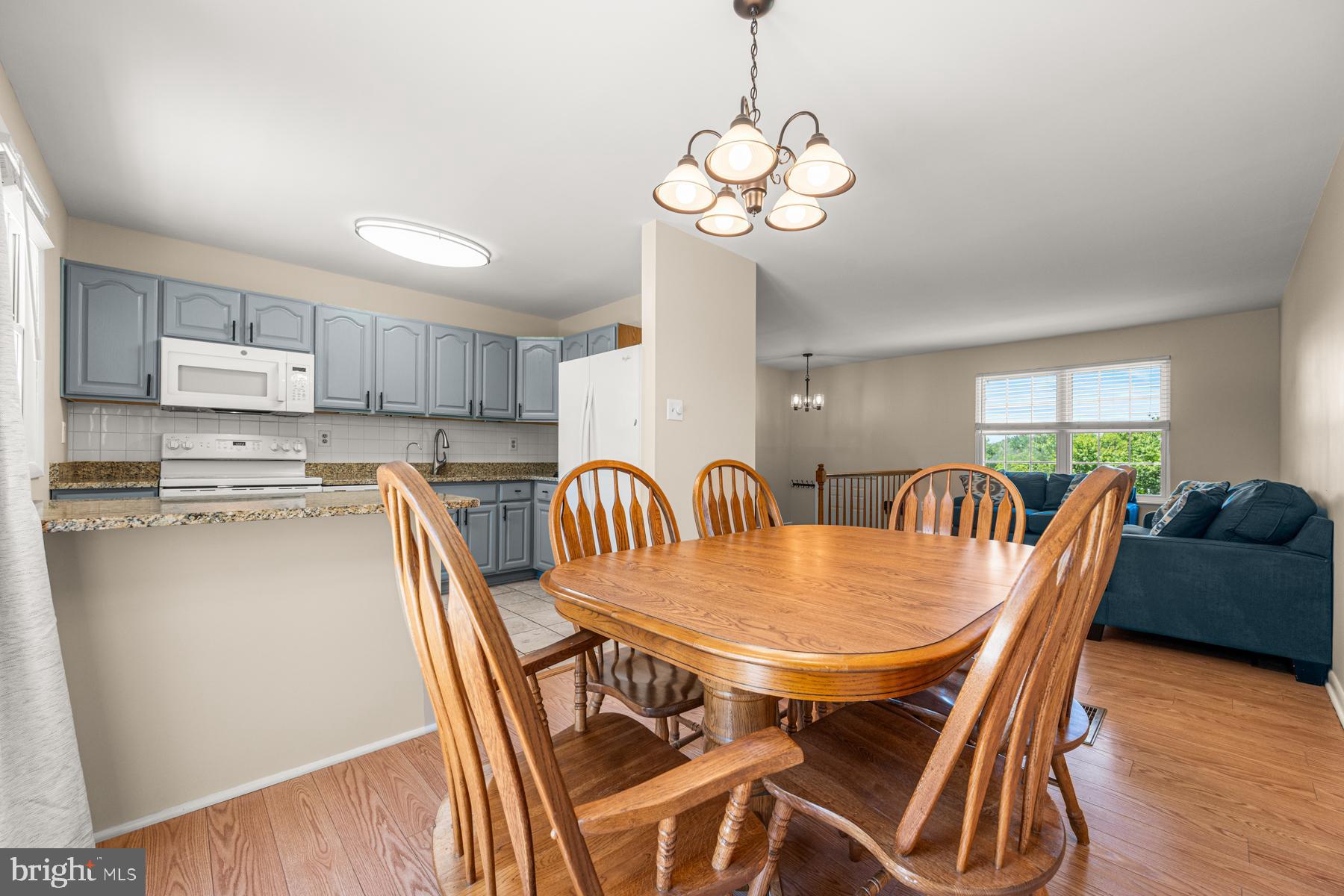 4285 Wolf Hill Drive Hampstead, MD 21074 - Photo 8 of 49 a view of a dining room with furniture wooden floor and chandelier