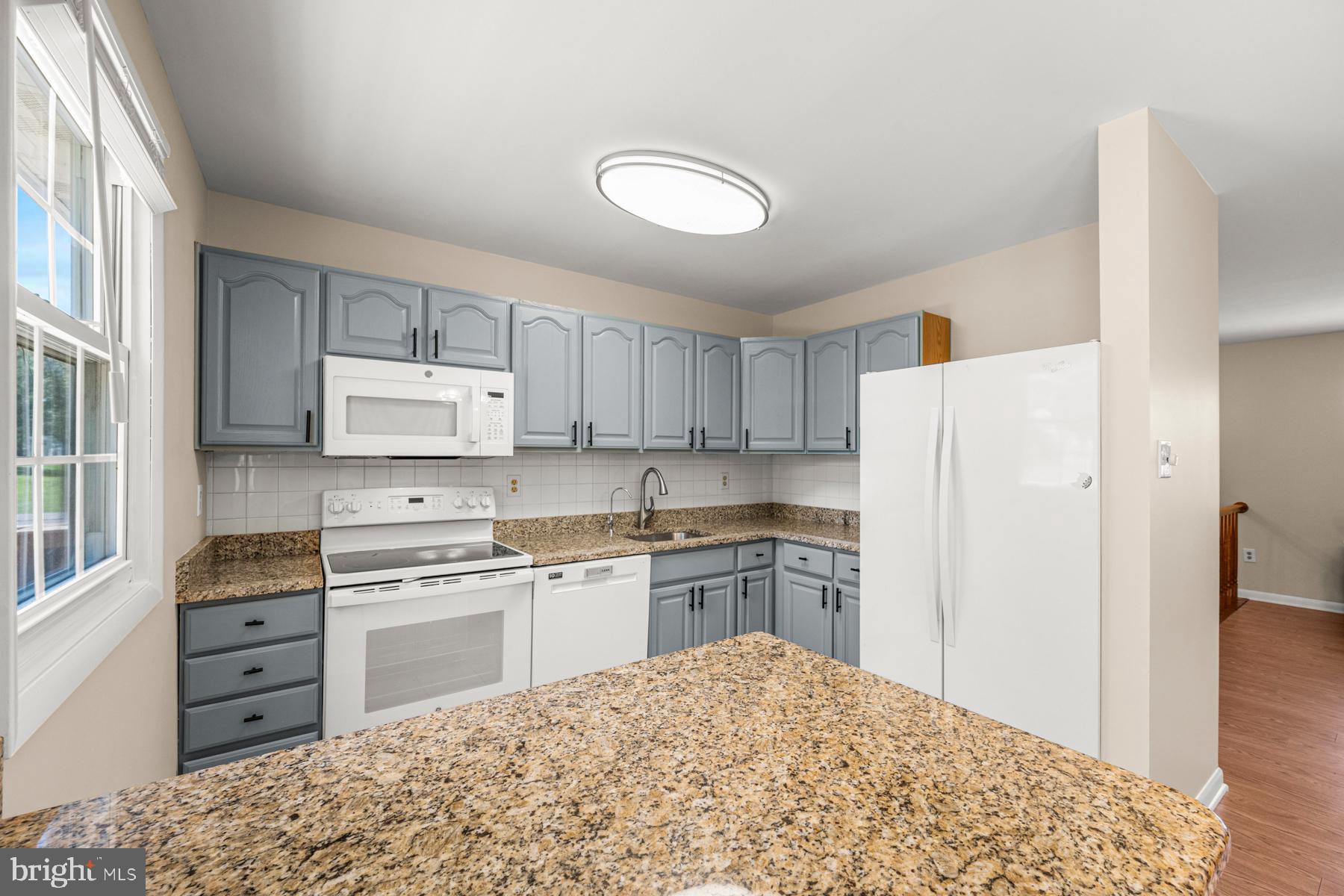 4285 Wolf Hill Drive Hampstead, MD 21074 - Photo 10 of 49 a kitchen with a refrigerator stove and sink