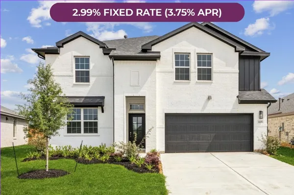 a front view of a house with a garden and garage