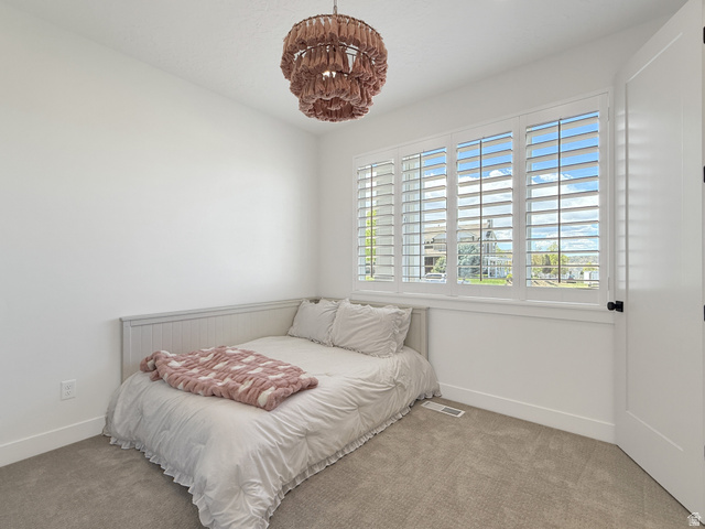 916 Rocky Mountain Way Elk Ridge, UT 84651 - Photo 32 of 54 Carpeted bedroom featuring baseboards and suspended lighting