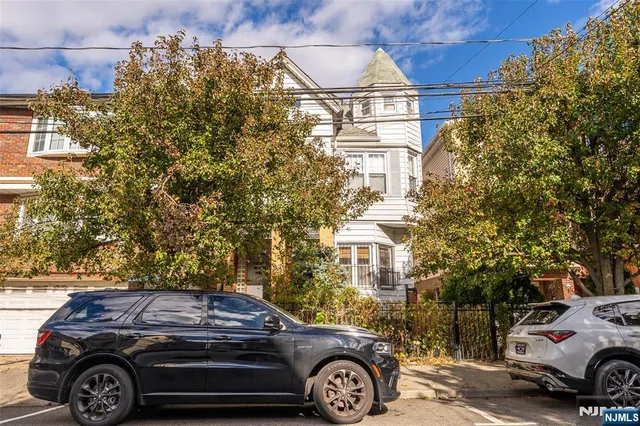a front view of a house with parking space